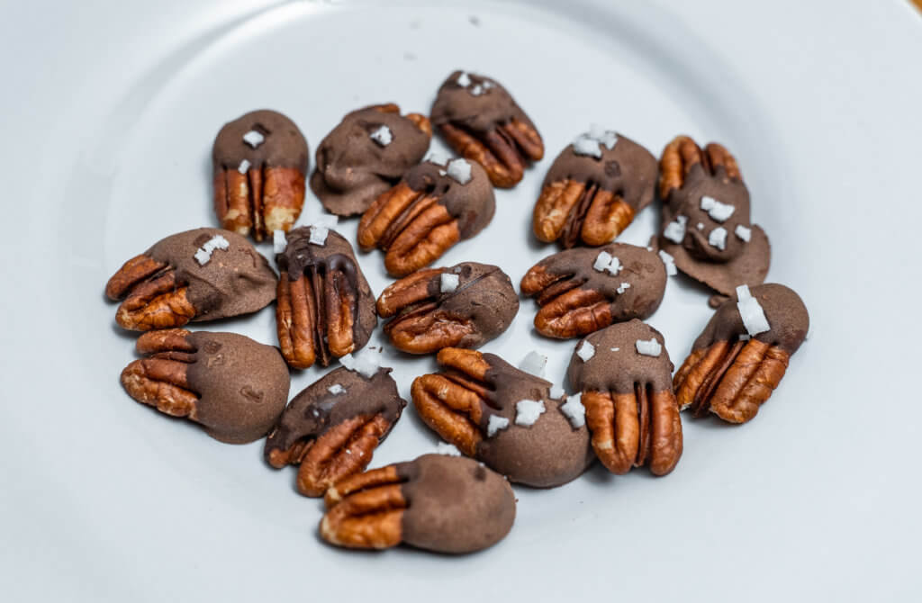 Chocolate covered pecans overhead on plate