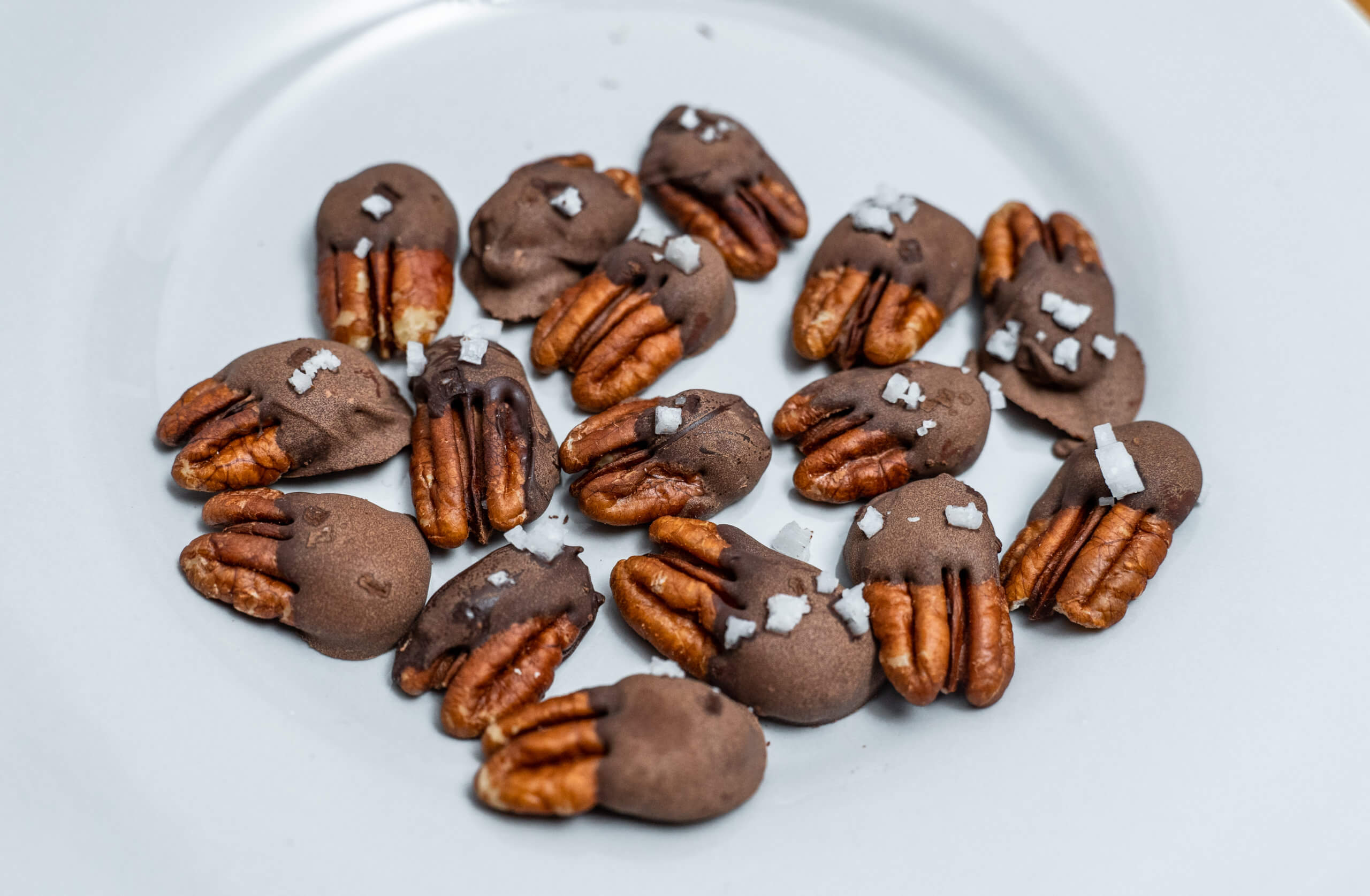 Chocolate covered pecans overhead on plate