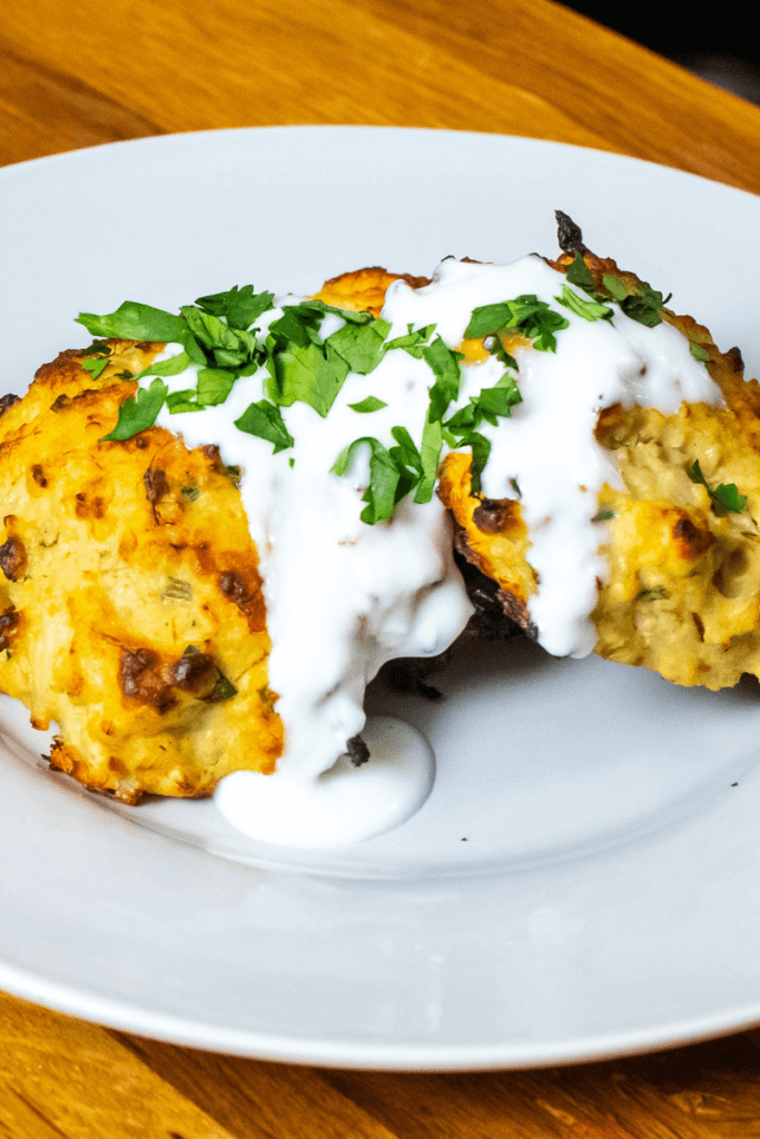crab cakes cooked in the air fryer on white plate topped with sauce