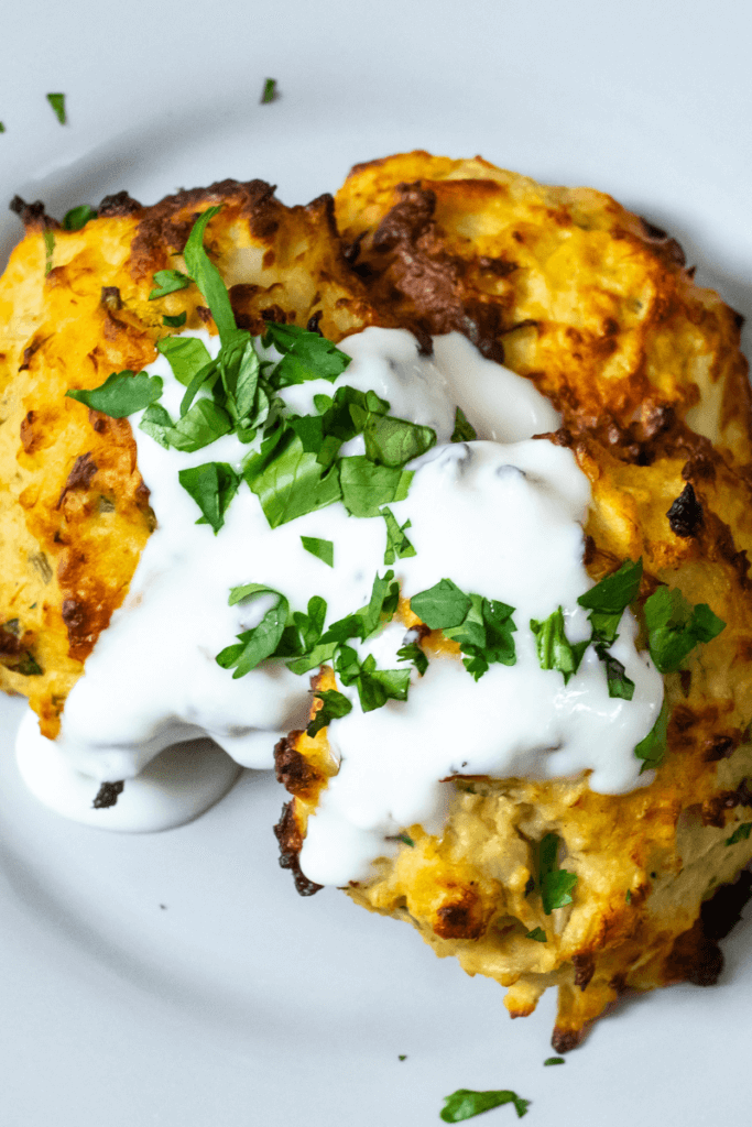 top view of air fryer crab cakes topped with seafood sauce