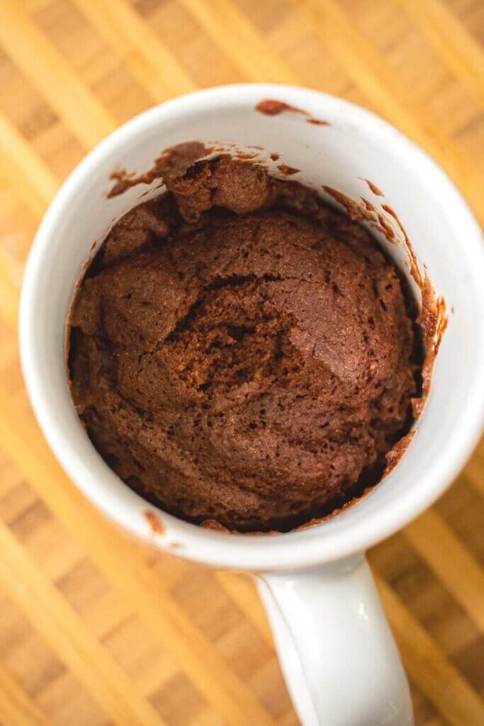 top shot of vegan brownie in a white coffee mug after cooking
