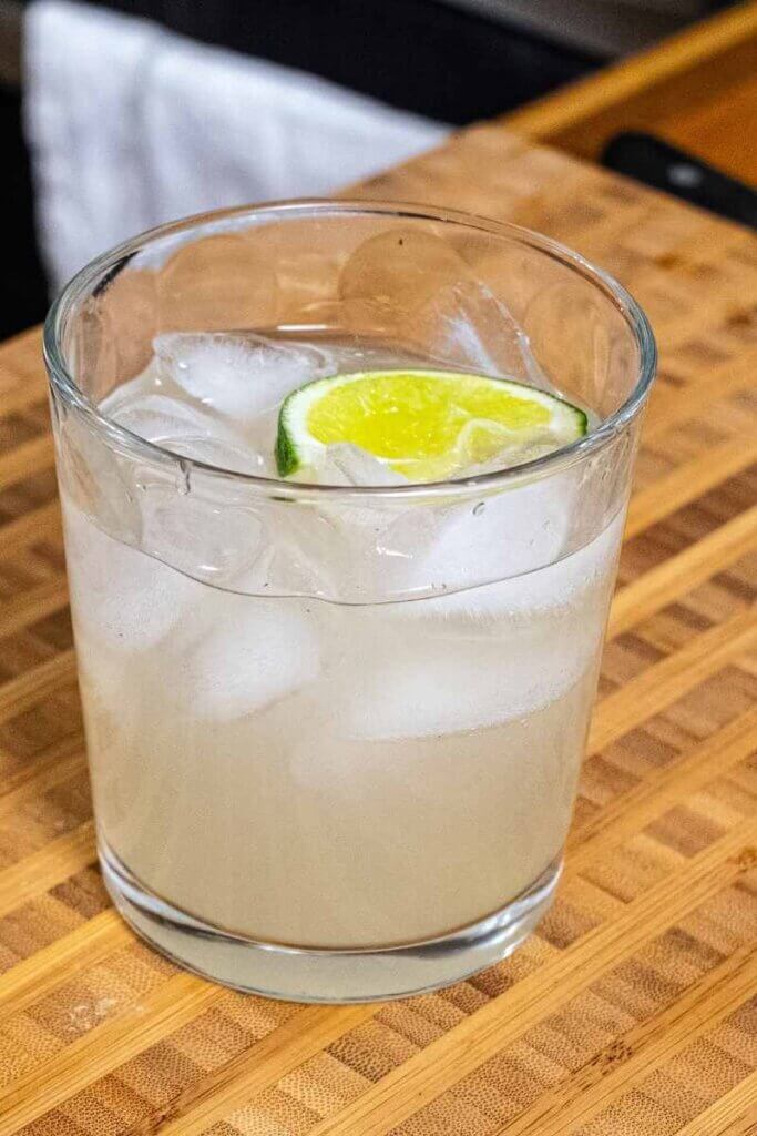 a rum moscow mule in a small glass with a lime wedge for garnish