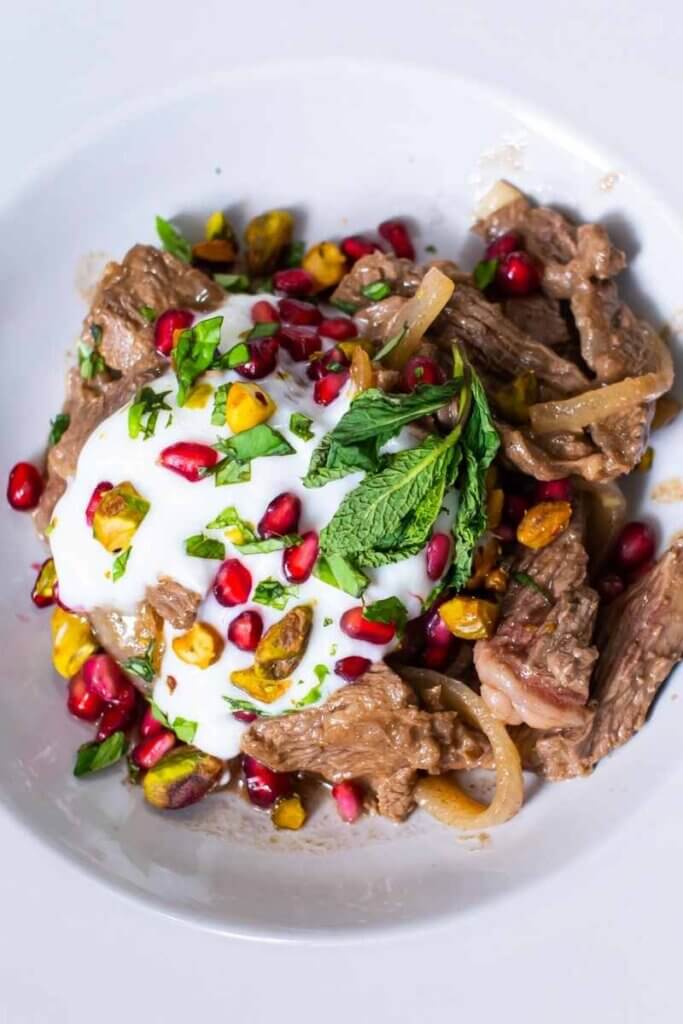 top shot of an easy lamb stir fry with onions in a white bowl