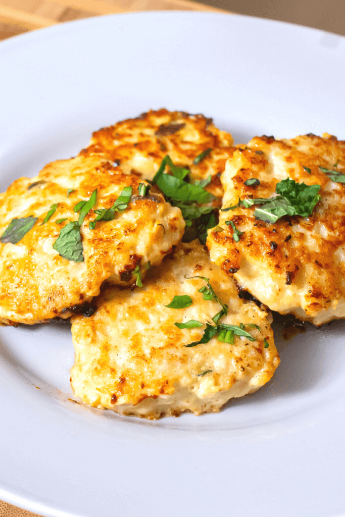 5 chicken breakfast sausage patties on a white plate