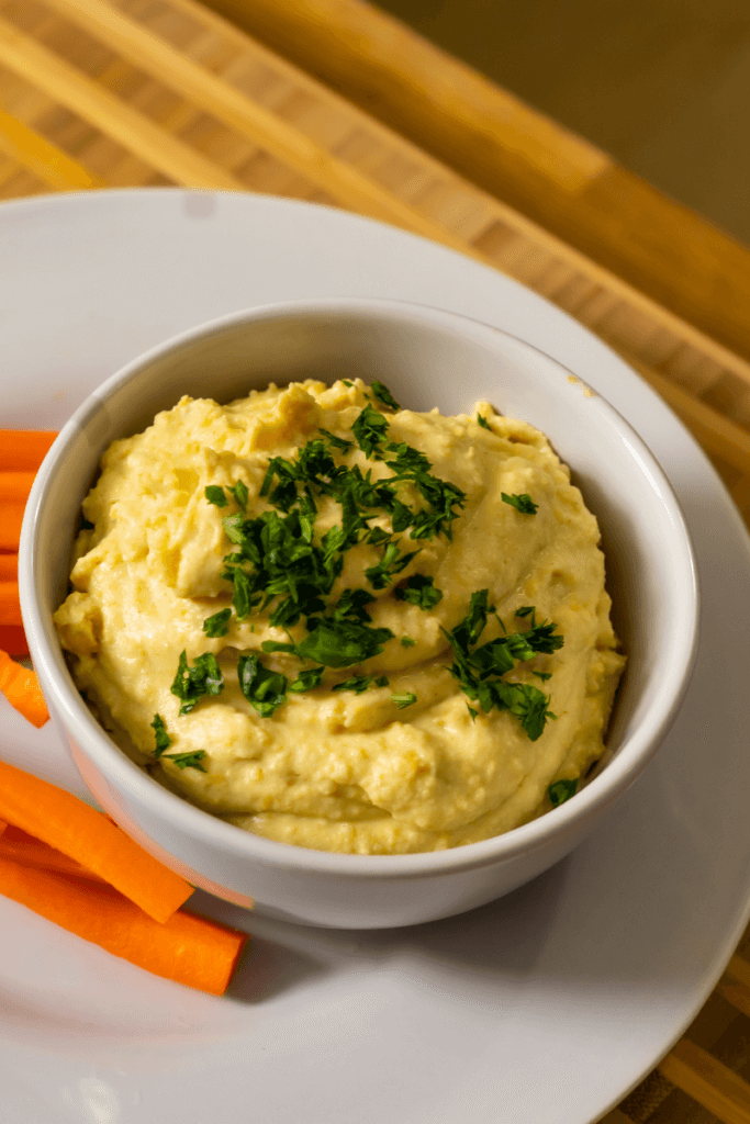 top view of yellow split pea hummus with carrots