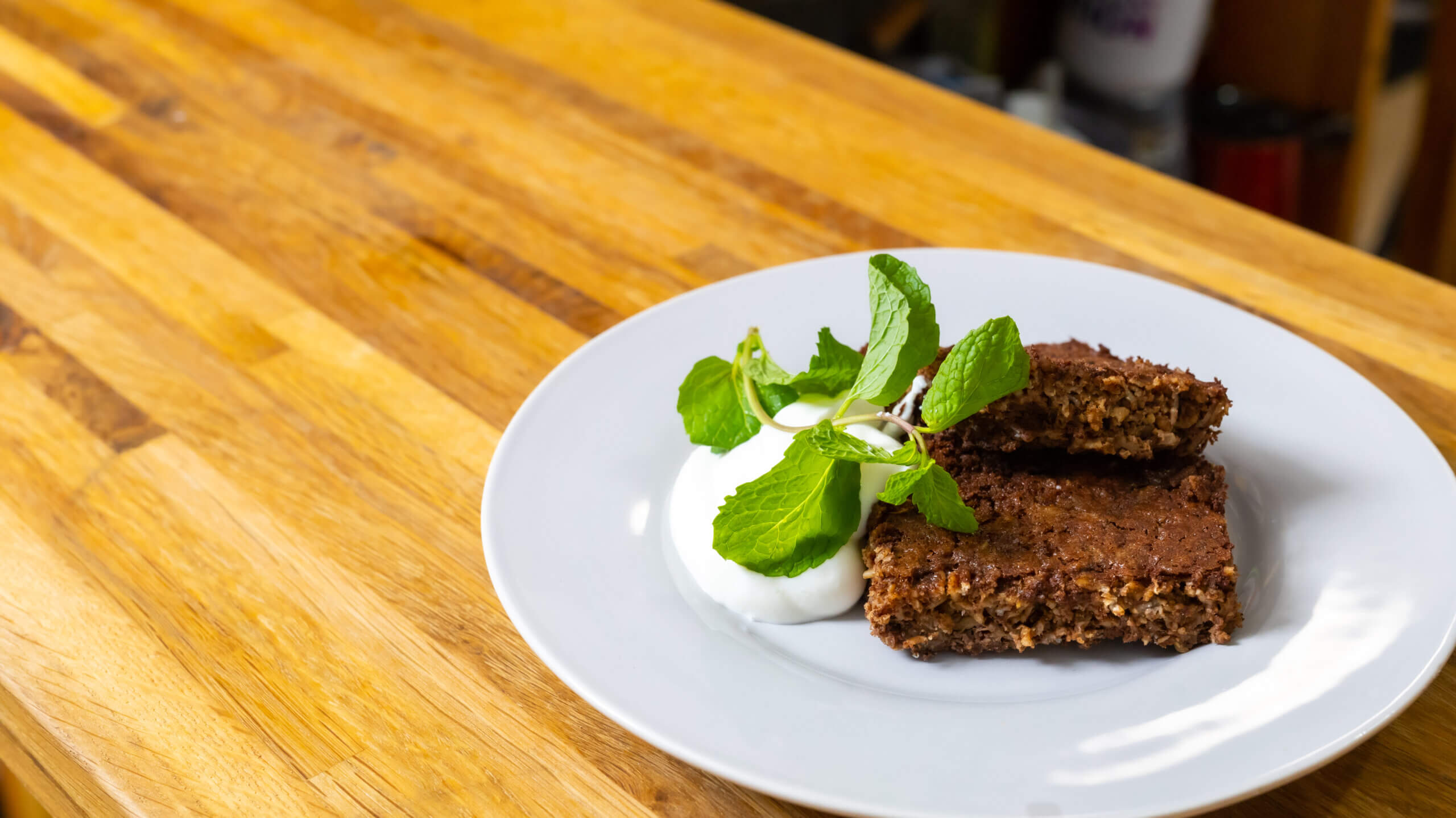 chocolate baked oats on a white plate next to garnish
