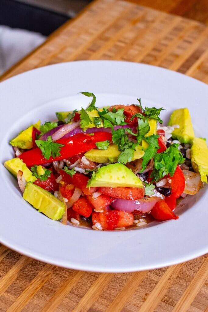 vegan fajita bowl in a white dish topped with cilantro