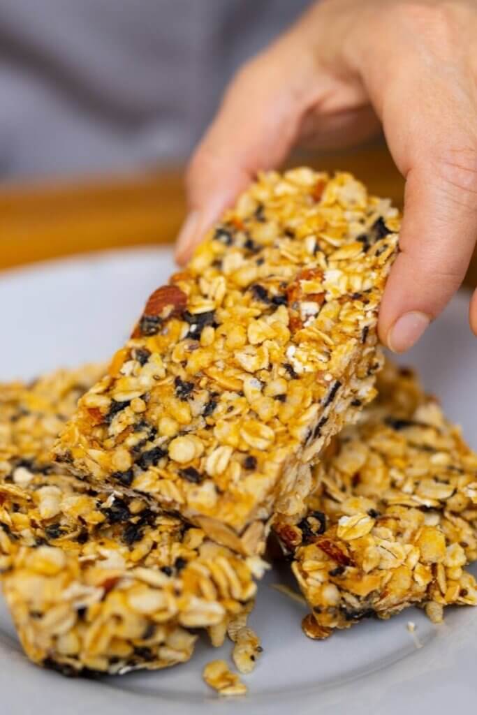 holding an oatmeal meal cherry breakfast bar