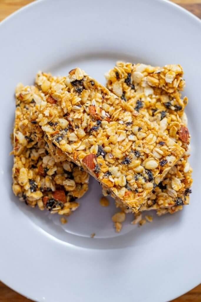top view of oatmeal cherry bars stacked on a white plate