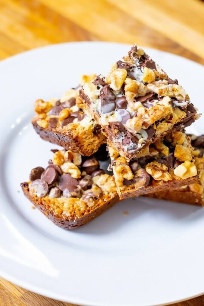 side view of hello dolly squares on a white plate