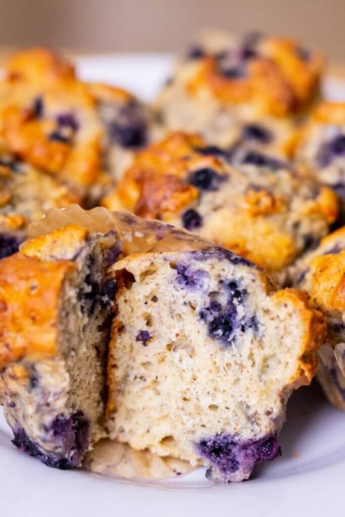 close up of blueberry flax seed muffins on a white plate