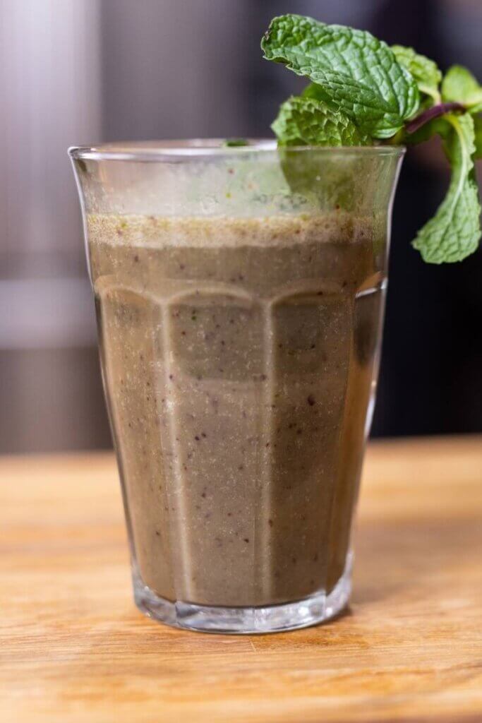 a healthy oat milk smoothie in a tall glass