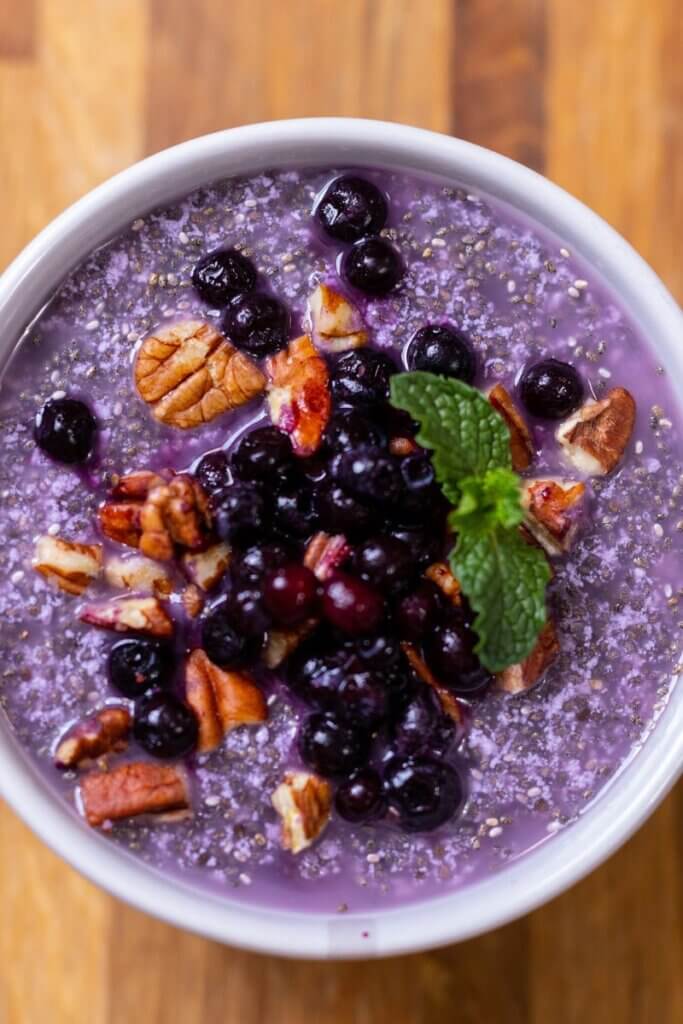 top view of warm chia pudding topped with berries and nuts