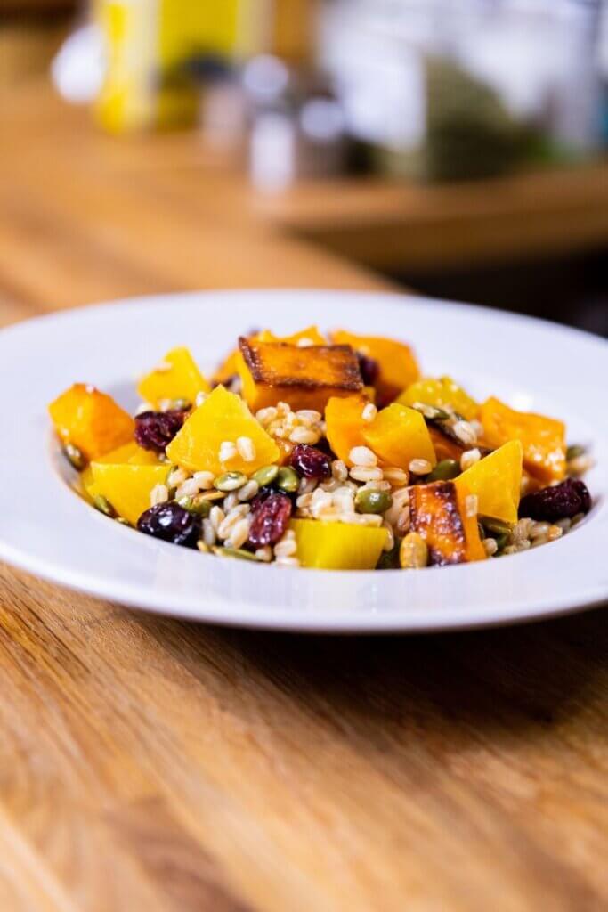 side view of butternut squash and beet salad in a bowl