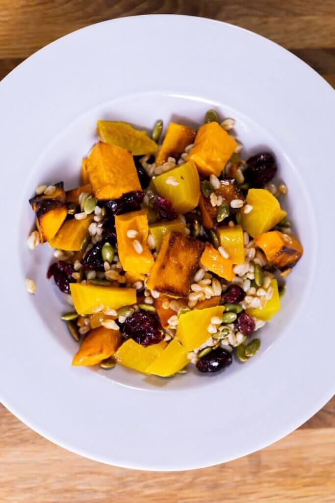 top view of butternut and beet salad in a large white bowl