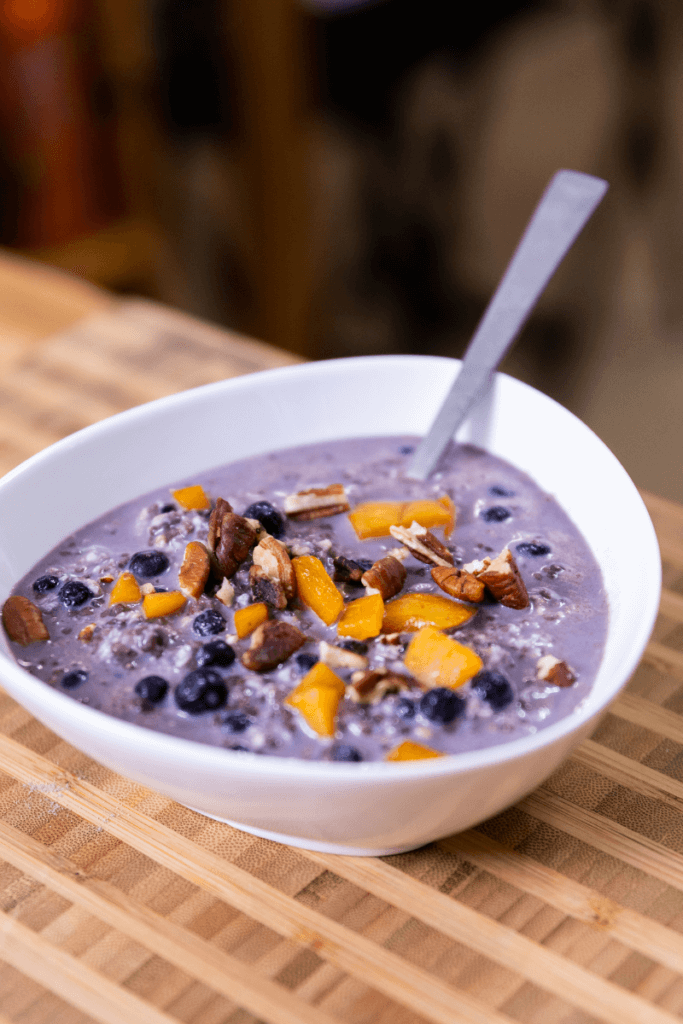 overnight oats with protein powder in a white bowl with a spoon