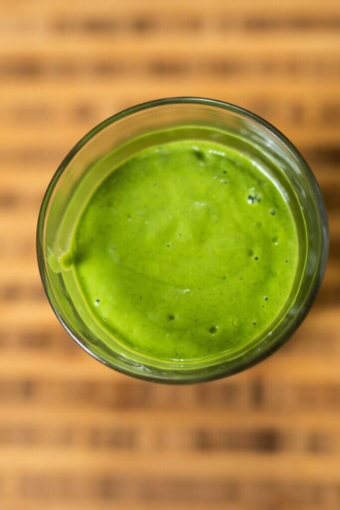 top view of a green goddess smoothie in a glass