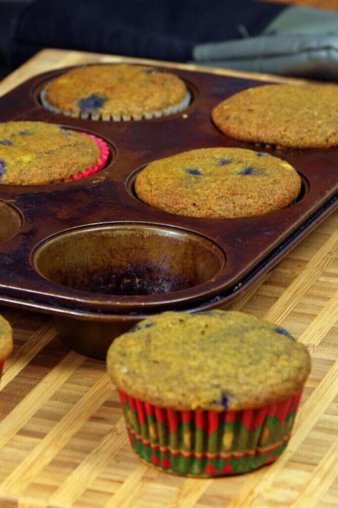A pan of baked blueberry buckwheat muffins.