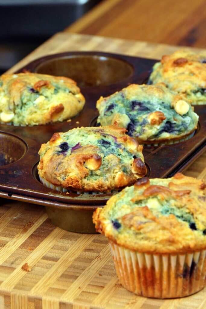 Blueberry white chocolate muffins in a muffin tin.