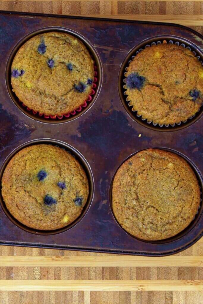 Top view of blueberry buckwheat muffins in a muffin tin.