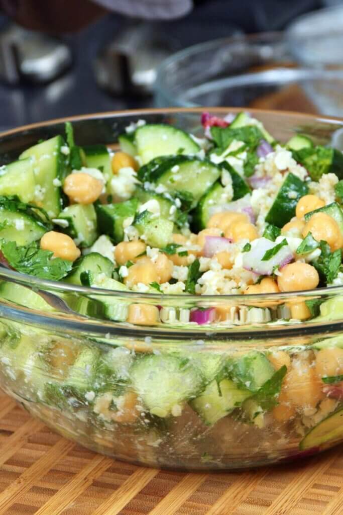 Millet salad in a glass mixing bowl.