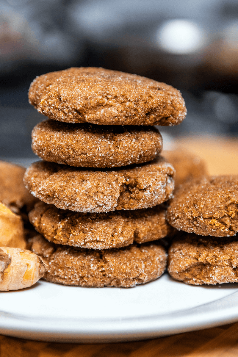 Ginger molasses cookies stacked on top of each other.