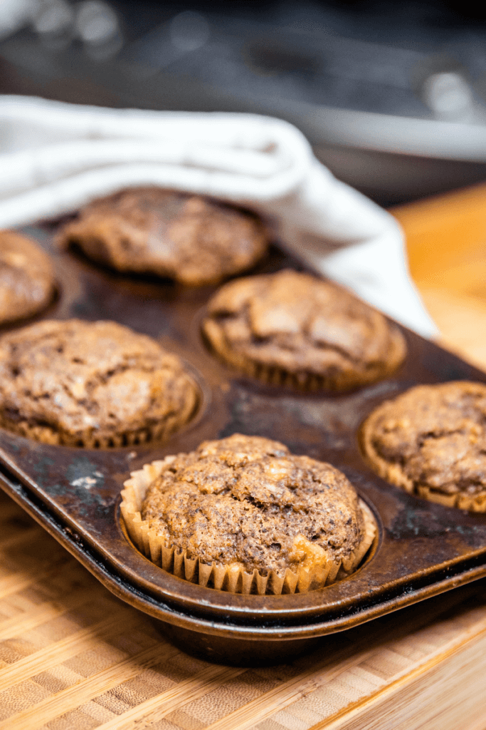 A pan of banana lentil muffins on the counter after baking.