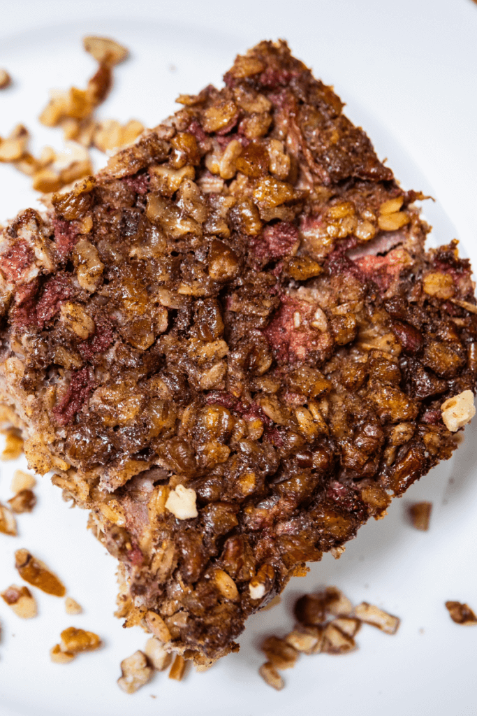A square of strawberry baked oatmeal on a plate.