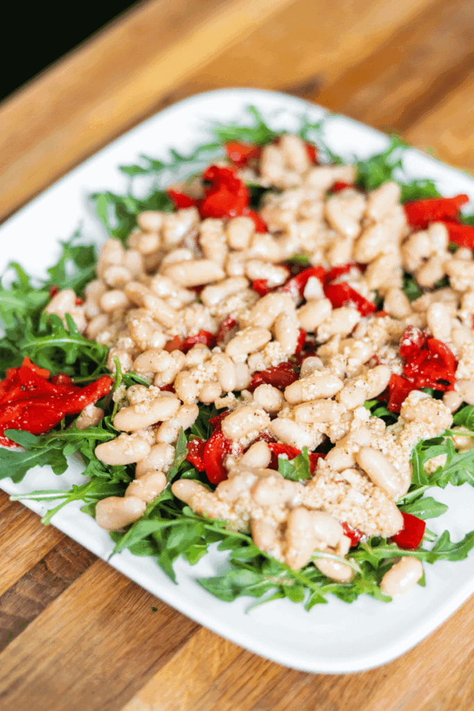Red pepper salad on a white plate.