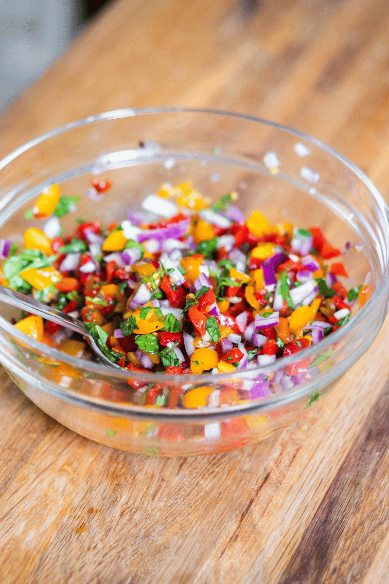 Roasted red pepper salsa in a glass bowl.