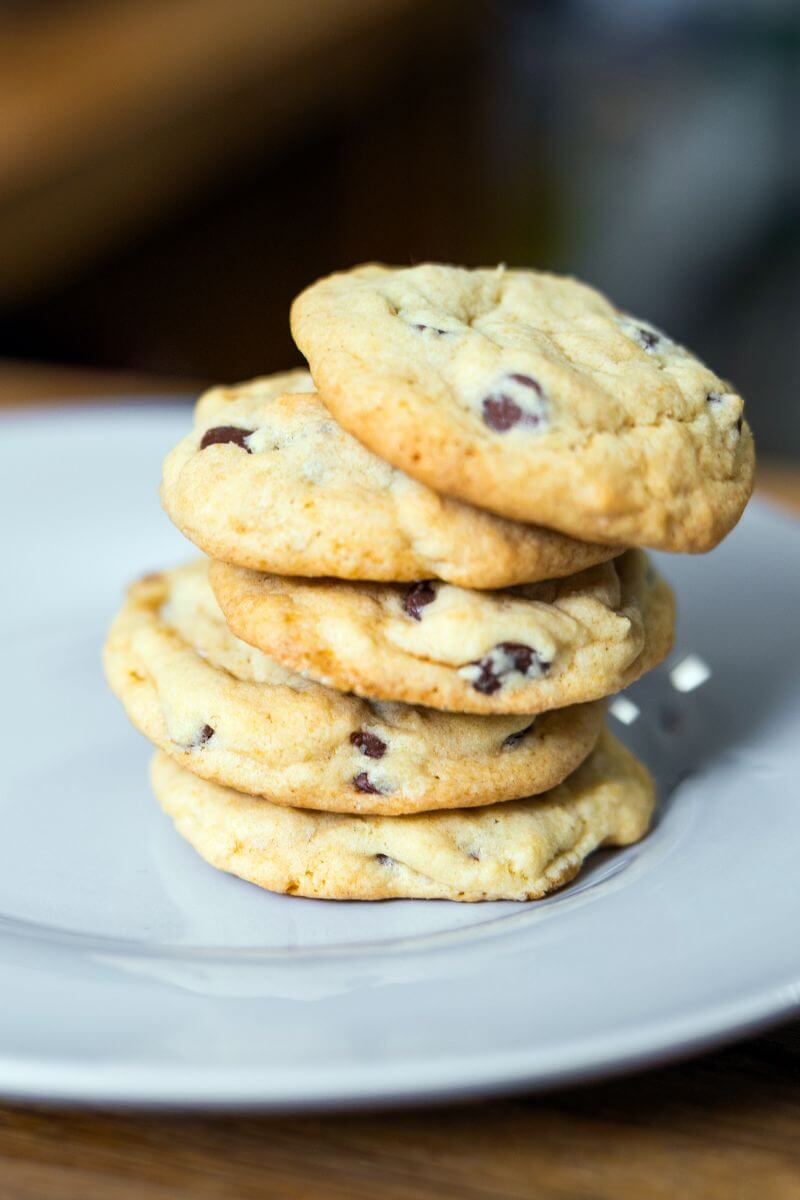 Stack of homemade bacon grease chocolate chip cookies on a white plate.
