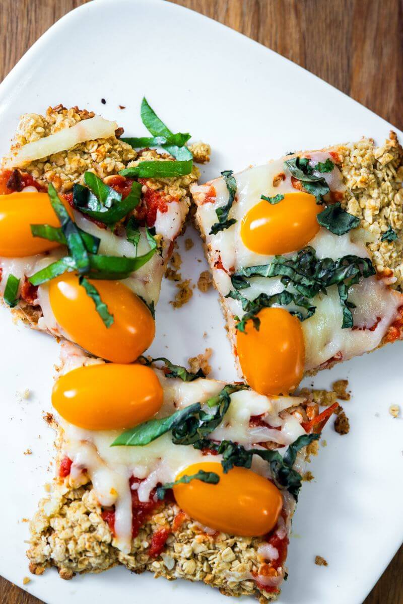 Top view of three pieces of oatmeal flatbreads on a white plate.